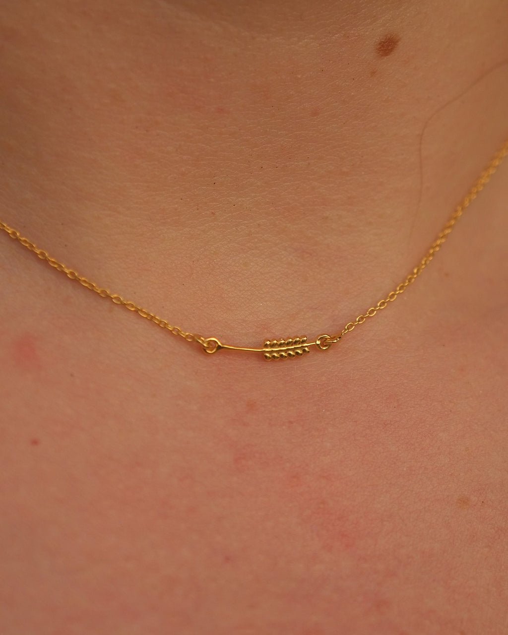 Close-up of the Sway Necklet pendant showing the intricate design and smooth finish on 18KT gold vermeil.