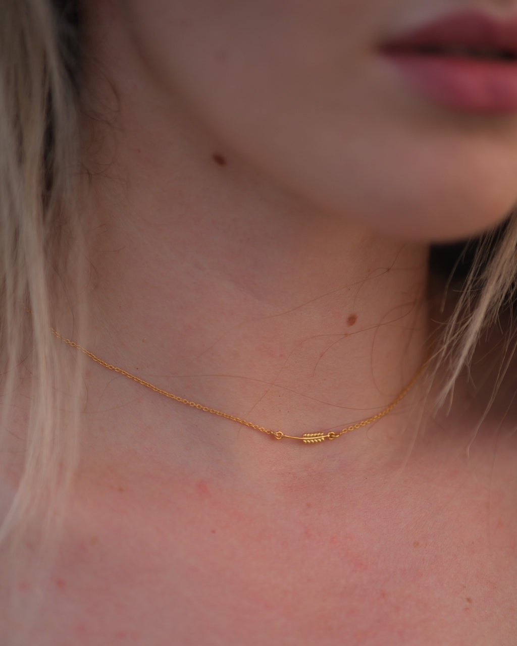 Model wearing the 18KT gold vermeil Sway Necklet, showcasing its delicate design and adjustable chain.