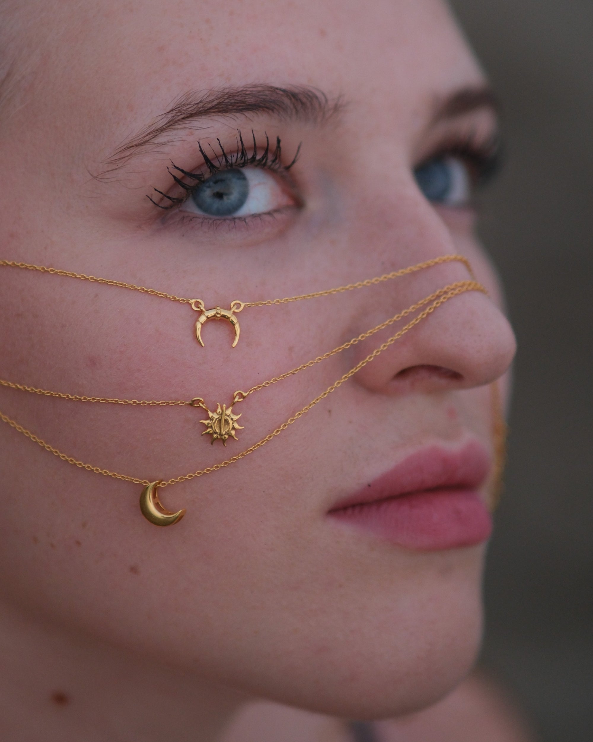 ide angle of handcrafted sun pendant necklace showcasing thickness and detail in gold vermeil